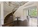 Elegant foyer with a grand curved staircase and gleaming hardwood floors at 426 Kirkbride Ct, Fort Mill, SC 29715