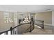 Upstairs landing featuring decorative chandeliers and wrought iron banister providing a view into the lower level at 426 Kirkbride Ct, Fort Mill, SC 29715