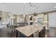 Open gourmet kitchen features a large island with stainless steel appliances, pendant lights, and bar seating at 426 Kirkbride Ct, Fort Mill, SC 29715