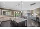 Open-concept kitchen with stone countertops and view into the living room with fireplace at 426 Kirkbride Ct, Fort Mill, SC 29715