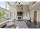 Bright living room features a stone fireplace, built-in shelving, large windows and dark hardwood floors at 426 Kirkbride Ct, Fort Mill, SC 29715