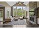 Bright living room featuring cathedral ceiling, large windows, fireplace and stone accent wall at 426 Kirkbride Ct, Fort Mill, SC 29715