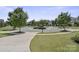 Picturesque street view showcasing well-maintained lawns, mature trees, and charming homes in a circular neighborhood at 426 Kirkbride Ct, Fort Mill, SC 29715