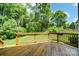Inviting wooden deck overlooking a lush backyard with mature trees and green lawn at 4312 Beech Wood Ct, Belmont, NC 28012