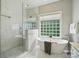 Modern bathroom featuring a glass shower, freestanding tub, and marble accents at 4312 Beech Wood Ct, Belmont, NC 28012