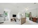 Bright and airy living room featuring a cozy sofa, media console, and desk with natural light from the windows at 4312 Beech Wood Ct, Belmont, NC 28012