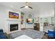 Spacious living room with fireplace, built-in shelving, and an open layout leading to the kitchen at 4312 Beech Wood Ct, Belmont, NC 28012