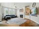 Bright living room featuring hardwood floors, fireplace, built-in shelving and many windows at 4312 Beech Wood Ct, Belmont, NC 28012