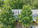 Aerial front view of a home with a neatly maintained front yard and surrounded by mature trees at 435 Hurston Cir, Charlotte, NC 28208