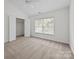 Neutral bedroom with large window and bi-fold closet doors at 435 Hurston Cir, Charlotte, NC 28208