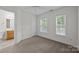 Bright bedroom with neutral carpet, ceiling fan, and access to adjoining bathroom at 435 Hurston Cir, Charlotte, NC 28208