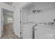 Convenient laundry room with washer, dryer, and wire shelving for storage at 435 Hurston Cir, Charlotte, NC 28208