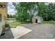 Backyard view with a storage building, a patio with lawn chairs, and a large grass lawn at 4720 Randleman Rd, Conover, NC 28613