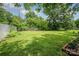 A large grassy backyard is shown with a brick-enclosed garden at 4720 Randleman Rd, Conover, NC 28613