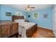 Bright bedroom with hardwood floors, ceiling fan, and natural light, creating a cozy and welcoming atmosphere at 4720 Randleman Rd, Conover, NC 28613
