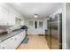 Functional kitchen design, featuring stainless steel appliances, white cabinetry, and tile flooring for easy maintenance at 4720 Randleman Rd, Conover, NC 28613