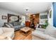 Cozy living room featuring a gray sofa, brick fireplace with wood stove and hardwood floors at 4720 Randleman Rd, Conover, NC 28613