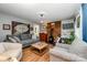 Cozy living room featuring a gray sofa, brick fireplace with wood stove and hardwood floors at 4720 Randleman Rd, Conover, NC 28613