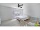 Bright bedroom with a ceiling fan, plush carpeting, and a large window for natural light at 502 Heritage Pkwy, Fort Mill, SC 29715