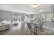 Bright living room featuring wood floors, grey walls, a large mirror, and sliding glass doors at 502 Heritage Pkwy, Fort Mill, SC 29715