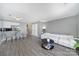 Open-concept living space with wood floors, grey walls, dining area, and access to the stairs at 502 Heritage Pkwy, Fort Mill, SC 29715
