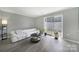 Living room showcasing wood floors, grey walls, and sliding glass doors to the patio at 502 Heritage Pkwy, Fort Mill, SC 29715