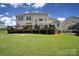 A backyard view of a home with a spacious lawn and entertainment deck at 510 Placid Ct, Tega Cay, SC 29708
