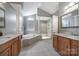 The bathroom features dual sinks, granite countertops, a glass-enclosed shower, and a soaking tub at 510 Placid Ct, Tega Cay, SC 29708