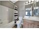 Bathroom with a vanity, mirror, full tub and shower combination and modern wood laminate floor at 510 Placid Ct, Tega Cay, SC 29708