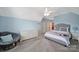 Bright bedroom with a ceiling fan, neutral walls, and natural light from a large window at 510 Placid Ct, Tega Cay, SC 29708