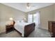 Cozy bedroom with a ceiling fan, soft carpet, and natural light from a large window at 510 Placid Ct, Tega Cay, SC 29708