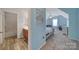 Bright bedroom with wood laminate flooring next to the full bathroom with a tub and shower at 510 Placid Ct, Tega Cay, SC 29708