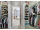 Dual walk-in closets showcase ample shelving and clothing rods, leading to the ensuite bathroom at 510 Placid Ct, Tega Cay, SC 29708
