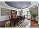 Formal dining room with hardwood floors, elegant chandelier, and large window providing ample natural light at 510 Placid Ct, Tega Cay, SC 29708