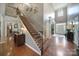 The foyer features hardwood floors, a staircase with wrought iron railings, and tall ceilings at 510 Placid Ct, Tega Cay, SC 29708