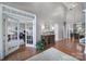 Grand foyer featuring soaring ceilings, hardwood floors, elegant lighting, and glass french doors to office at 510 Placid Ct, Tega Cay, SC 29708