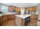 The bright kitchen has wooden cabinets, a large island with seating, and stainless steel appliances at 510 Placid Ct, Tega Cay, SC 29708