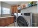 The laundry room has wooden cabinets, countertops, and modern appliances at 510 Placid Ct, Tega Cay, SC 29708