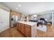 Open concept kitchen, dining, and living area with natural light, hardwood floors, and stainless steel appliances at 510 Placid Ct, Tega Cay, SC 29708