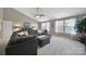 Cozy living room with a plush gray sectional sofa, soft neutral carpet and plenty of sunlight at 510 Placid Ct, Tega Cay, SC 29708