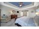 Spacious main bedroom with ensuite access and closet featuring a tray ceiling and carpet floors at 510 Placid Ct, Tega Cay, SC 29708