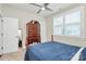 Cozy bedroom with natural light, a ceiling fan, and a classic wooden dresser at 5129 Whitman Ave, Matthews, NC 28105