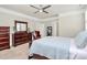 Comfortable bedroom featuring a large bed, dresser, and a view to an ensuite bathroom at 5129 Whitman Ave, Matthews, NC 28105