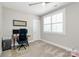 Bright bedroom with plantation shutters, wooden desk and a comfortable office chair at 5129 Whitman Ave, Matthews, NC 28105