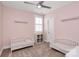 Charming Bedroom featuring two white cribs, neutral color scheme and plantation shutters at 5129 Whitman Ave, Matthews, NC 28105