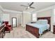 Spacious bedroom with a ceiling fan, large bed, and doorway view of ensuite bathroom at 5129 Whitman Ave, Matthews, NC 28105
