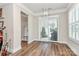 Bright dining area featuring hardwood floors, sliding glass doors, and modern light fixture at 5129 Whitman Ave, Matthews, NC 28105