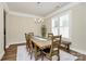 Bright dining room featuring a wooden table with seating for eight and natural light from shuttered windows at 5129 Whitman Ave, Matthews, NC 28105
