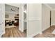 Hallway with wood floors that leads to a powder room and living room at 5129 Whitman Ave, Matthews, NC 28105