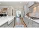 Modern kitchen with stainless steel appliances, gray cabinetry, and a large farmhouse sink at 5129 Whitman Ave, Matthews, NC 28105